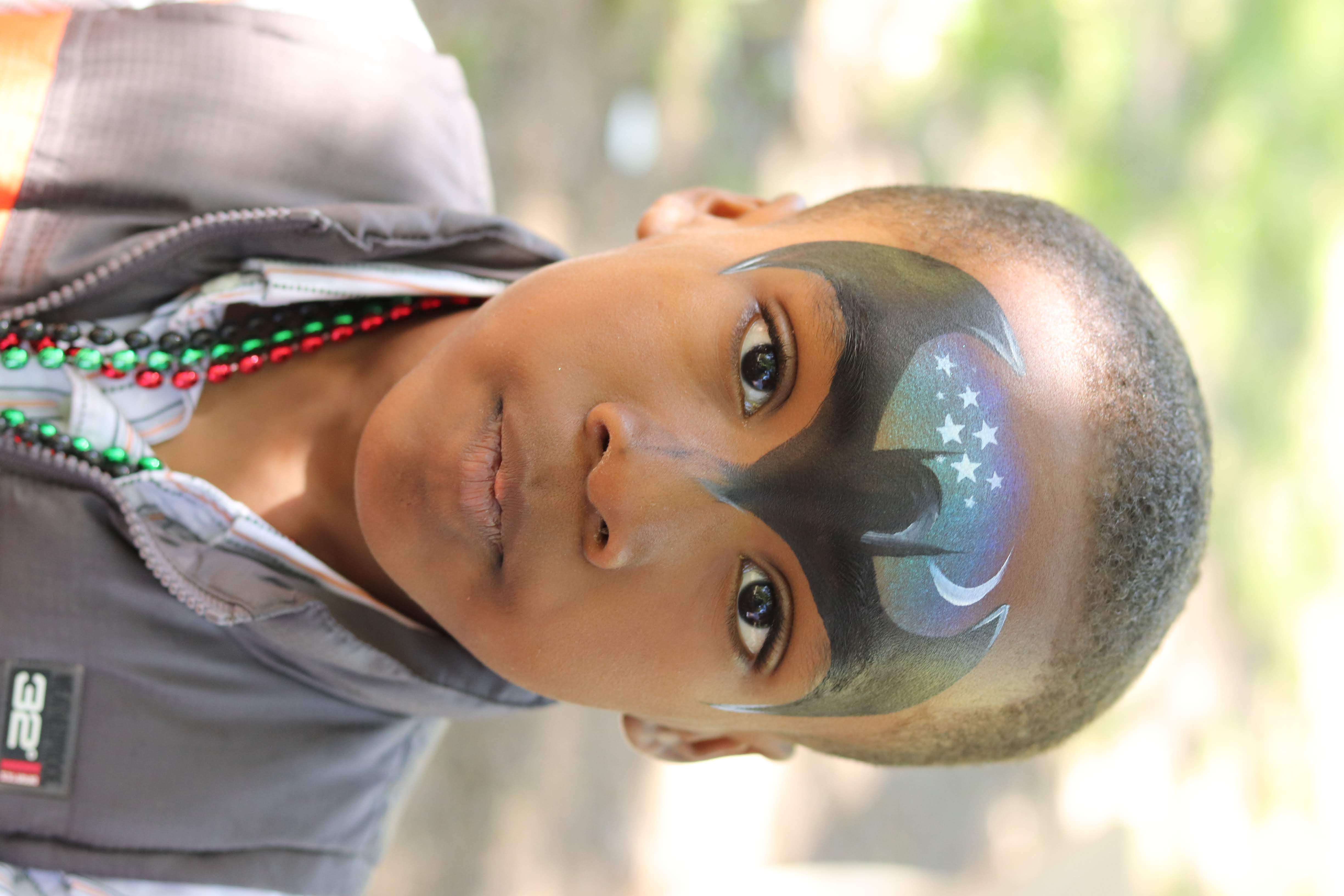 Young boy with Batman face paint